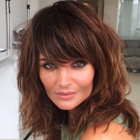 5. Medium Brunette Shag with Thick Bangs
