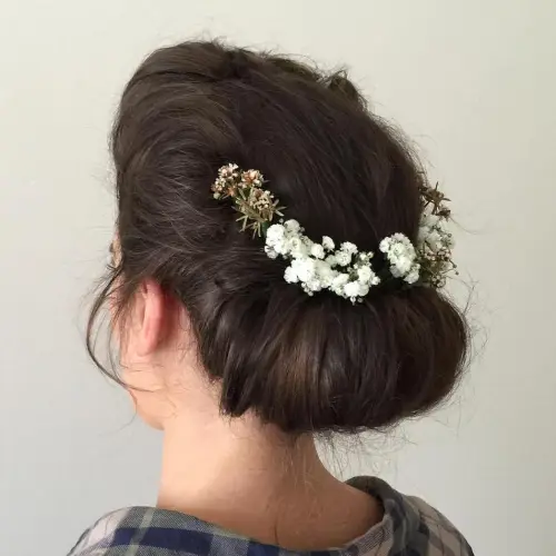 6. Soft Updo with a Floral Hair Piece