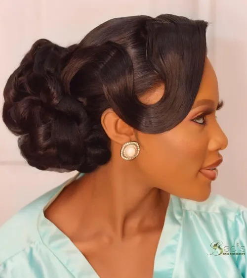 15. Curly Bun with Side Swept Bangs