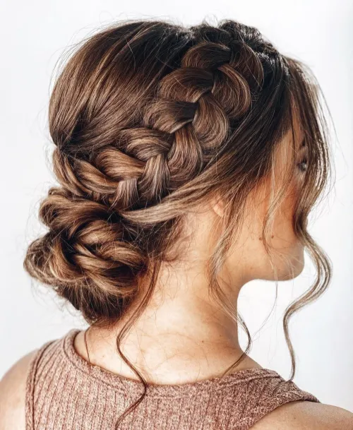 2. Braided Bun with Face Framing Tendrils
