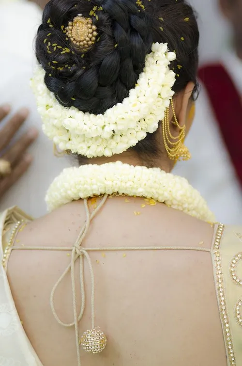 5. Elegant Braided Updo with Fresh Flowers
