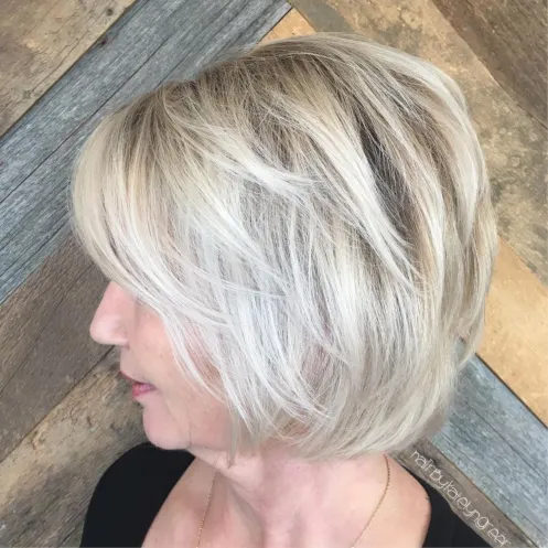 7. Ash Blonde Layered Bob with Bangs
