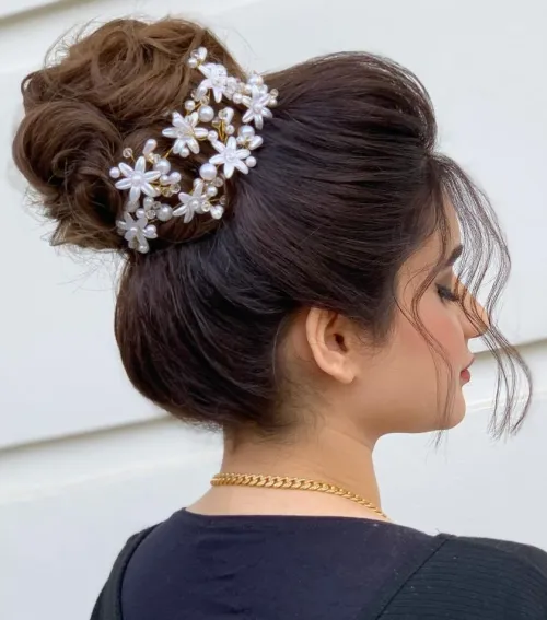 9. Voluminous Hairdo with Curled High Bun
