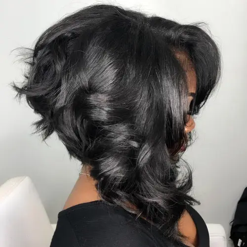 10. Angled Black Cut with Soft Curls
